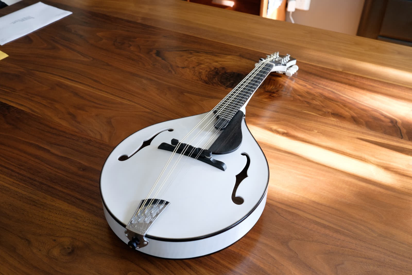 A-model mandolin — top, white-finished, three-quarter view