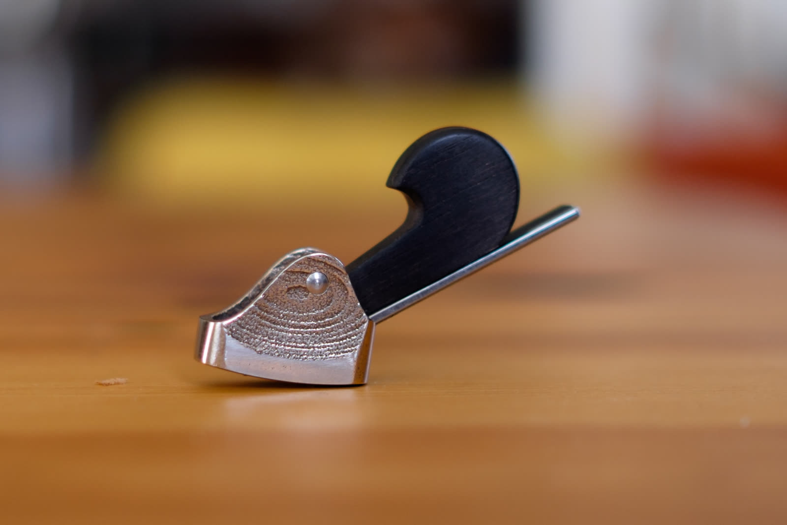 Miniconvex thumb plane — cheek, stainless steel and bronze, as-cast texture beside the polished sole