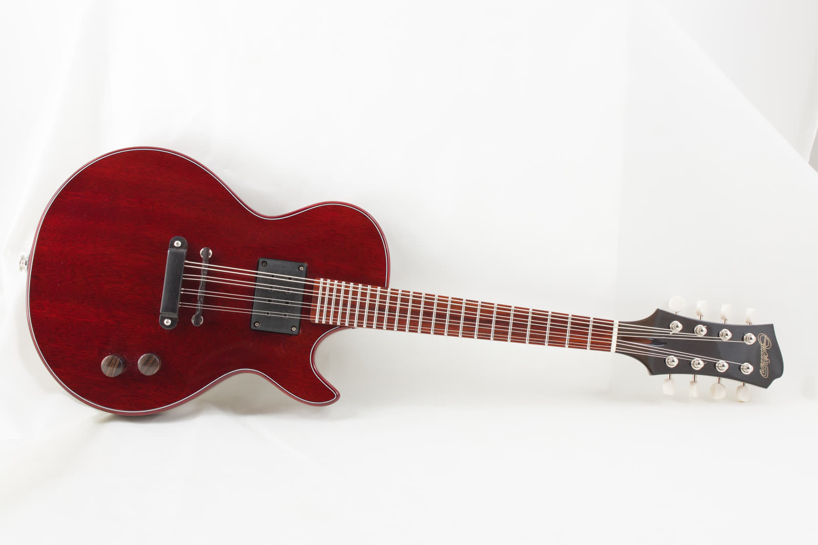 Electric mandolin — top, red lacquer solidbody, resting diagonal on white